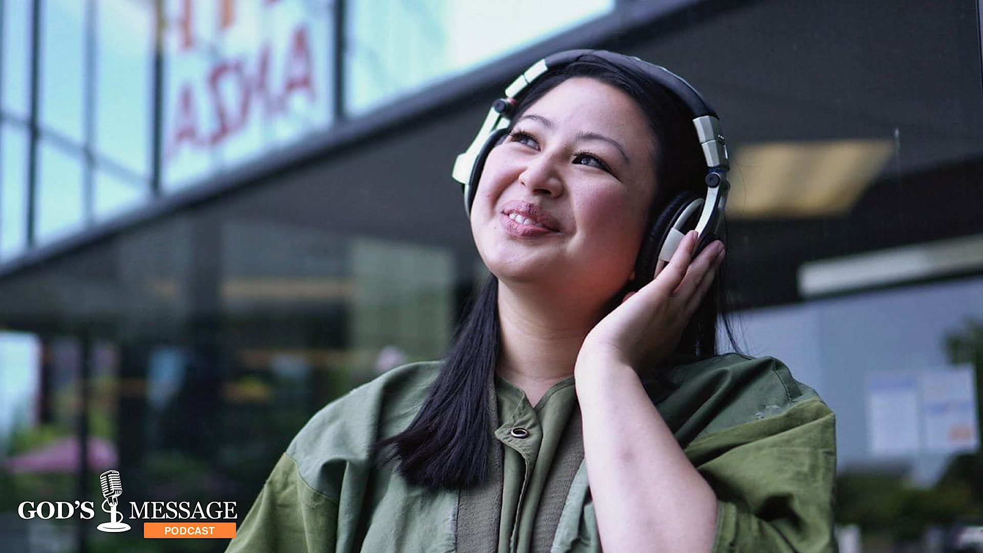 Woman smiling while listening to a podcast