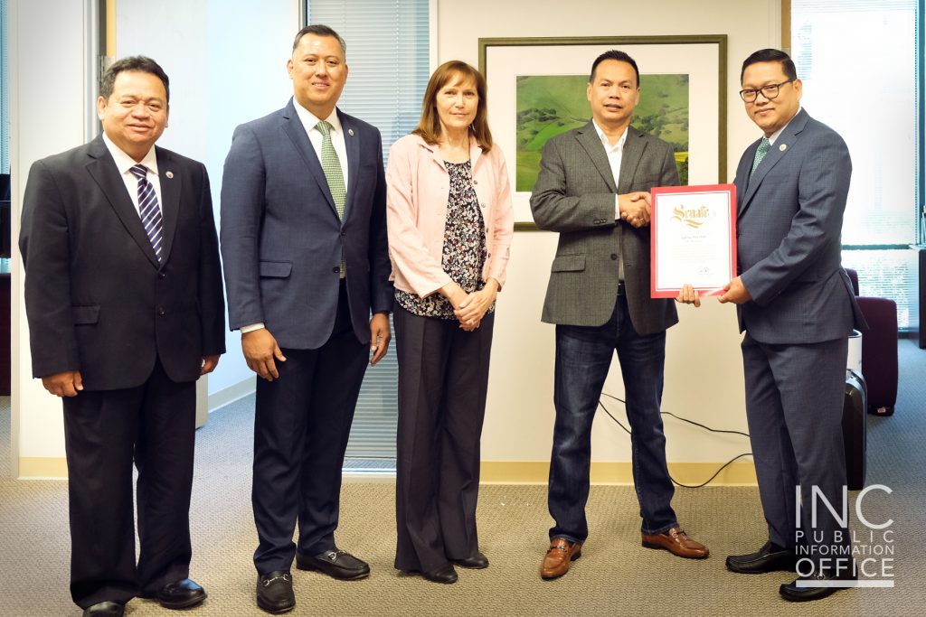 A group of individuals pose for the photo while receiving a Certificate of Recognition from the Office of California State Senator.